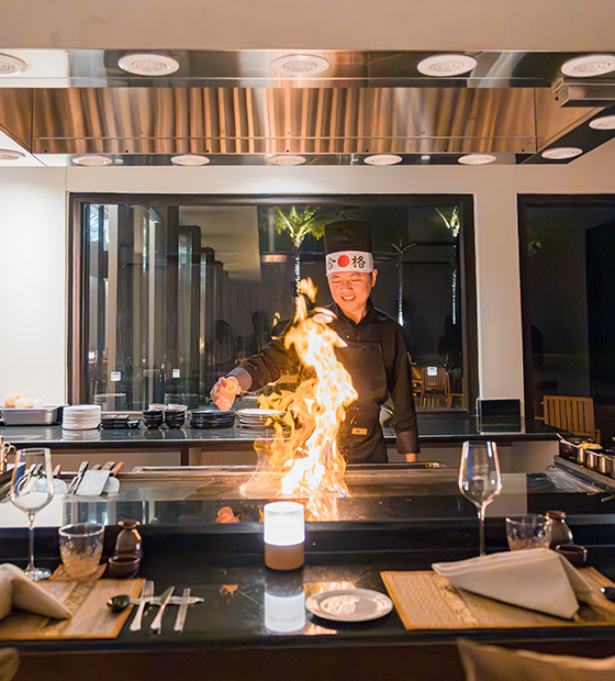 Teppanyaki chef prepares dishes with flames at East Restaurant in Kuda Villingili