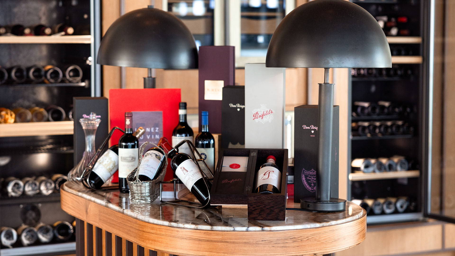 Collection of wine bottles displayed in the wine cellar at Kuda Villingili's Cigar Lounge