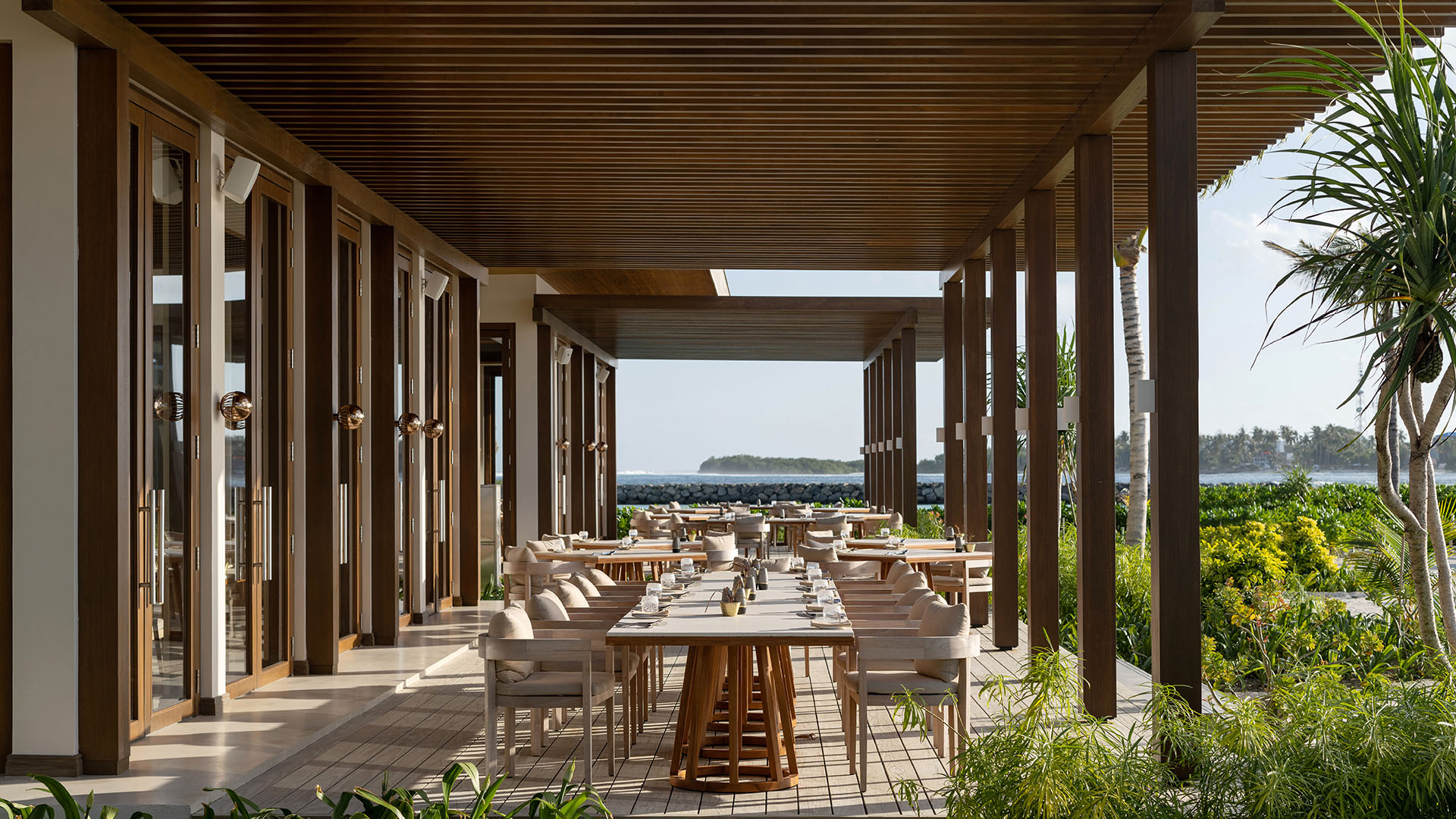 Outdoor dining area at The Restaurant with beach views in Kuda Villingili