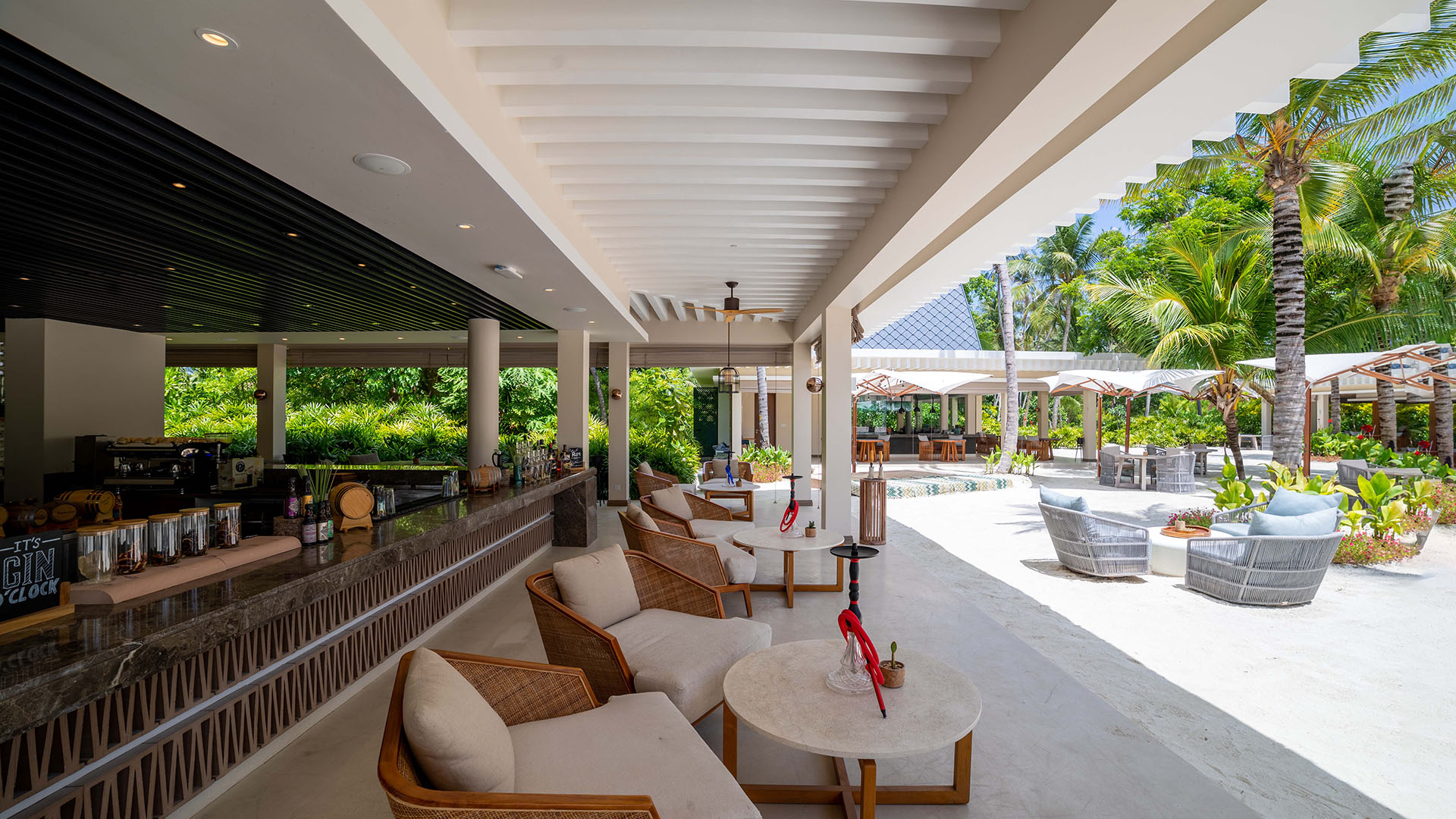 Outdoor dining area of The Bar at Kuda Villingili featuring comfortable seating