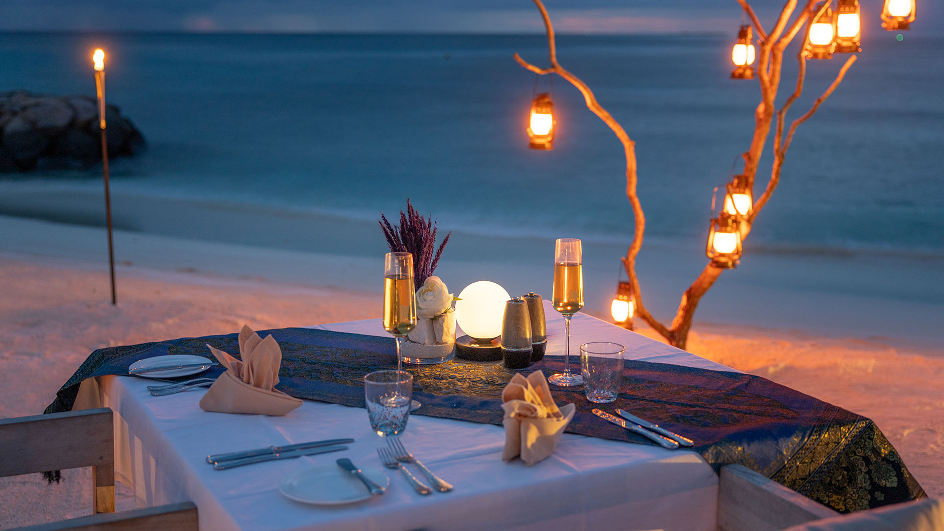 Romantic beachside dining at Kuda Villingili with soft lighting