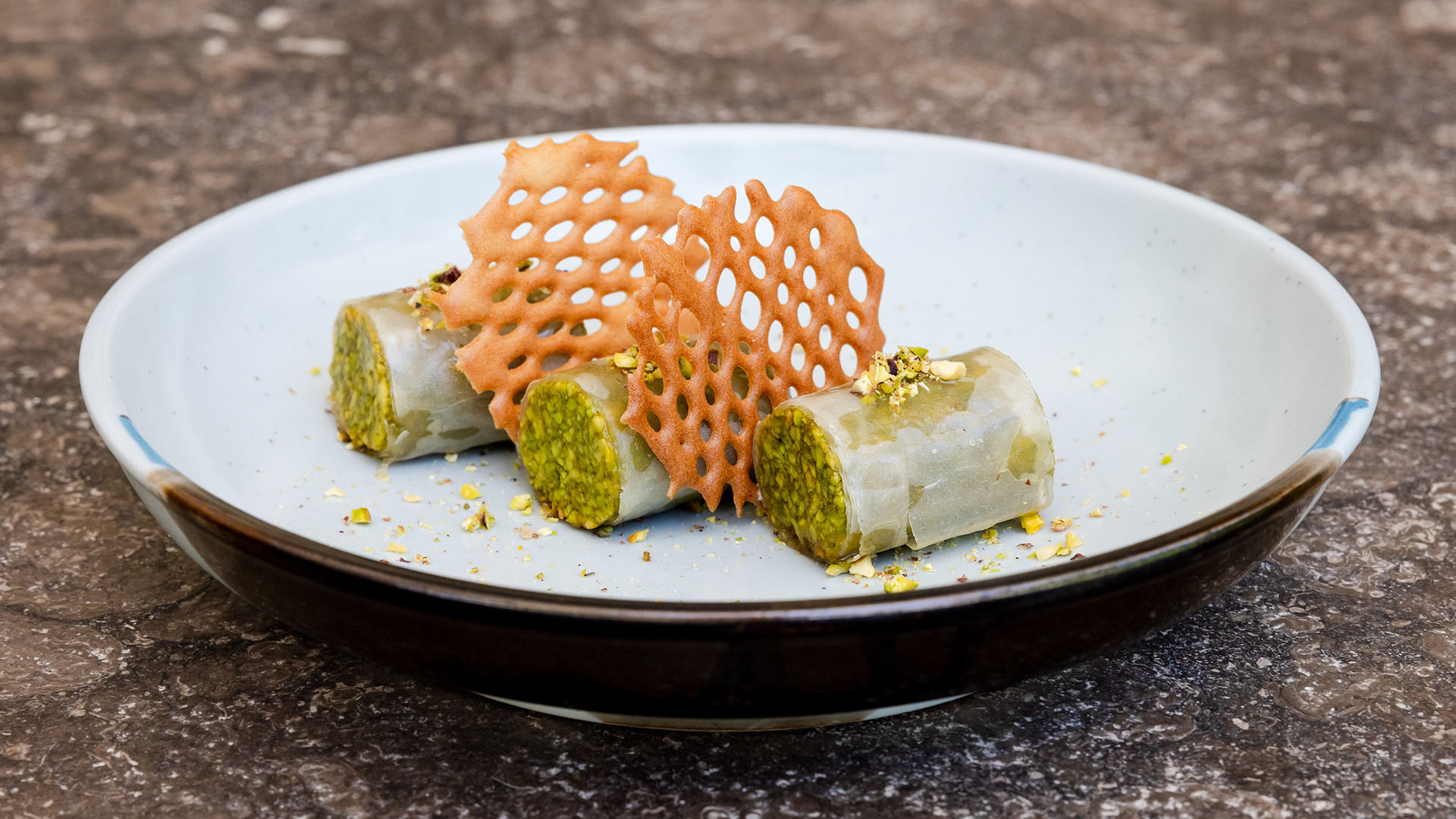 Dessert with wafer crisps served on a plate at Kuda Villingili Maldives restaurant