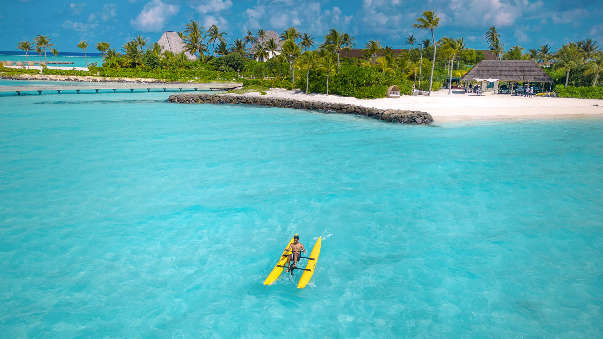 Aerial view of a guest riding a water bike on the sea at Kuda Villingili