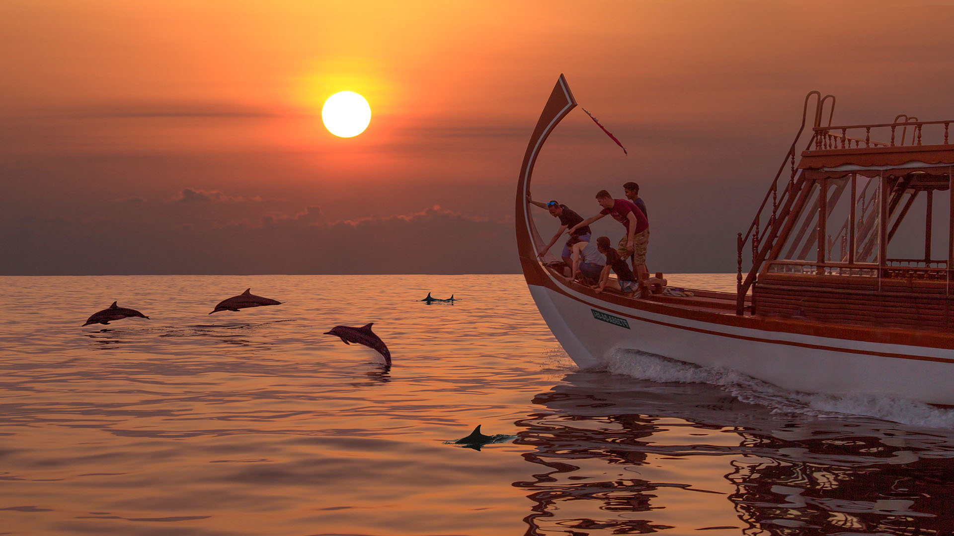 Cruise guests whale watching at sunset in Kuda Villingili Maldives