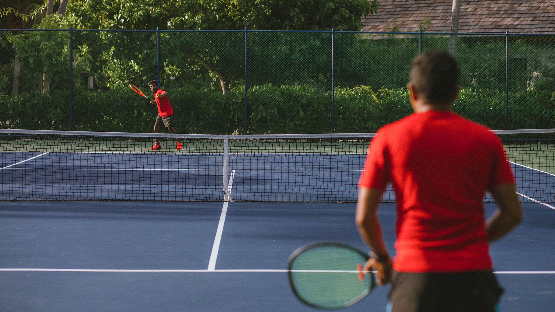 Guests playing tennis at Kuda Villingili's tennis court