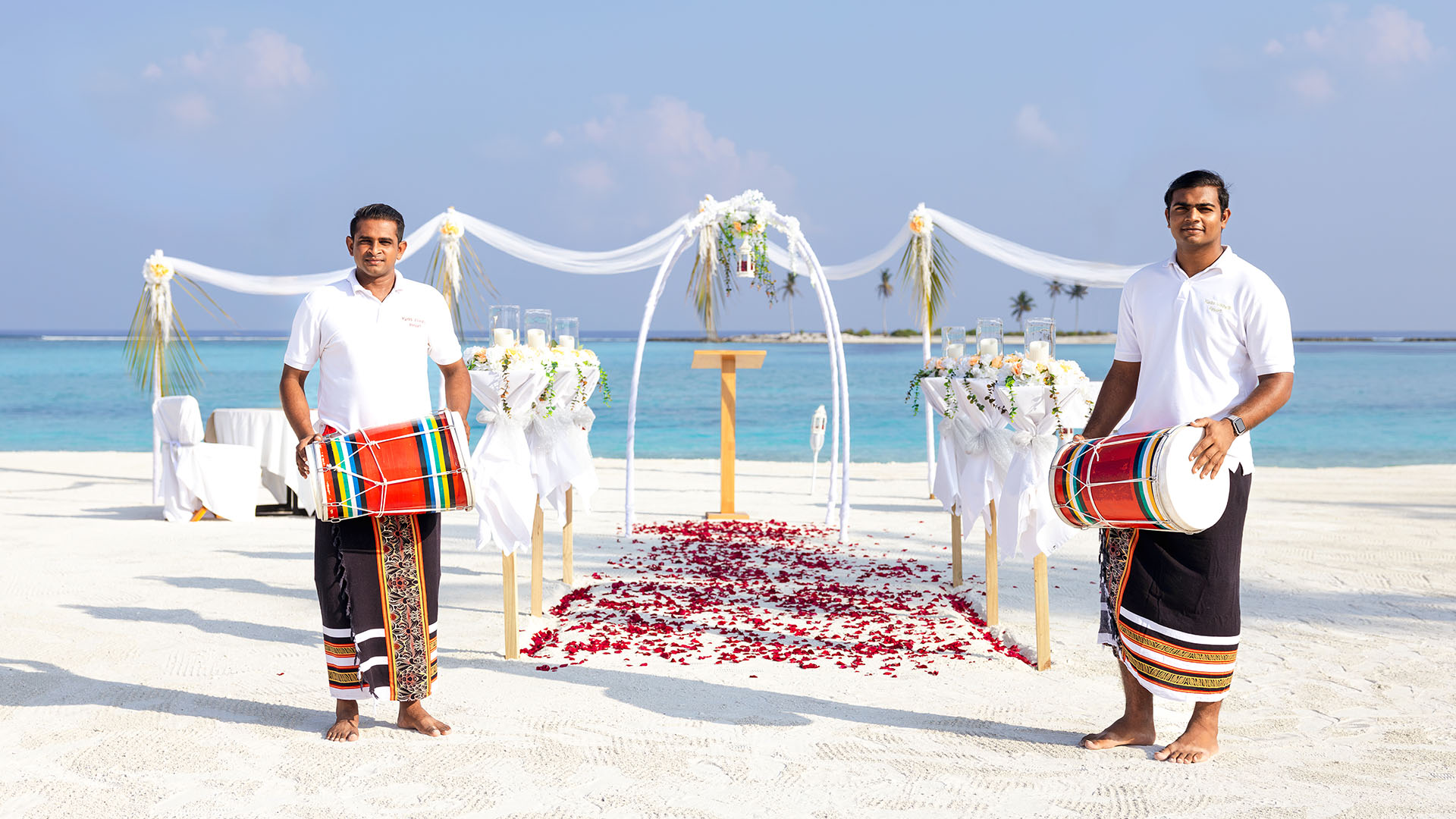 Staff with drums preparing for a beach wedding at Kuda Villingili Maldives