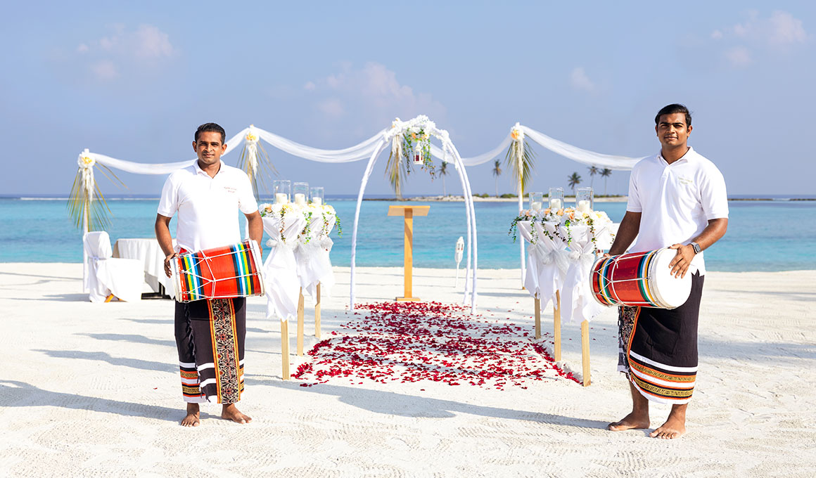 Staff with drums preparing for a beach wedding at Kuda Villingili Maldives