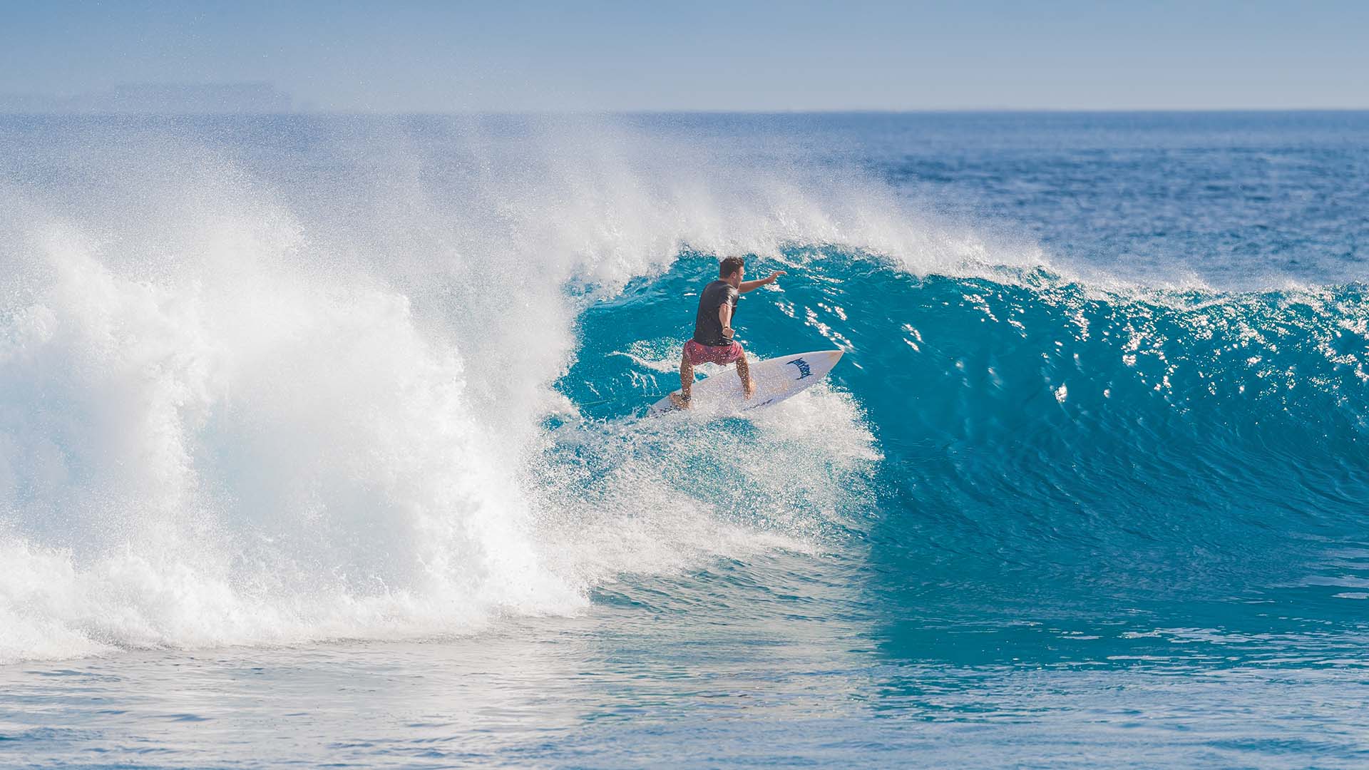 Guest enjoying an adventurous surfing experience at Kuda Villingili Maldives