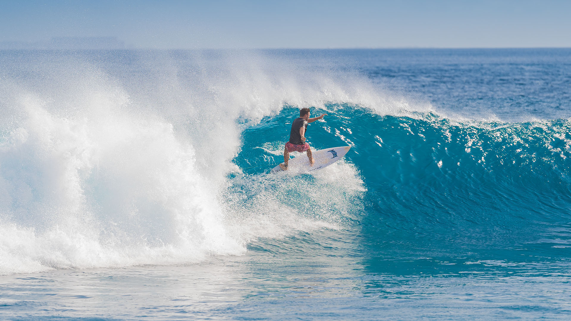 Guest enjoying a thrilling surfing adventure at Kuda Villingili Maldives