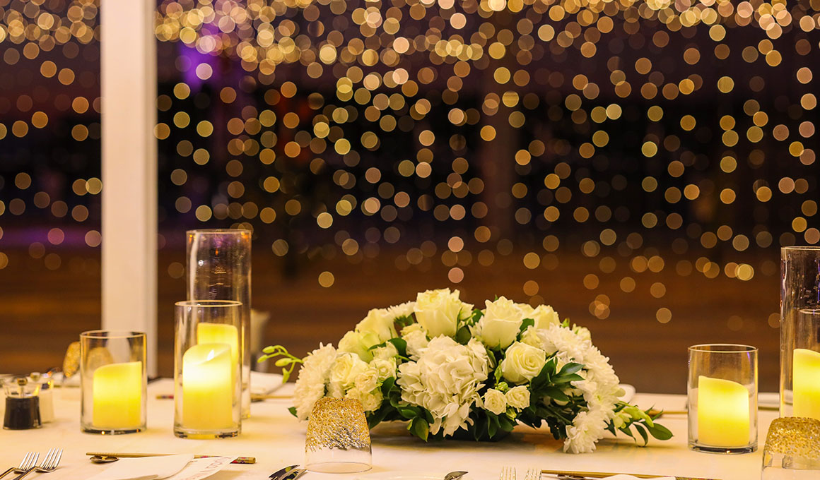 Beautifully arranged table with candles and flowers at Kuda Villingili