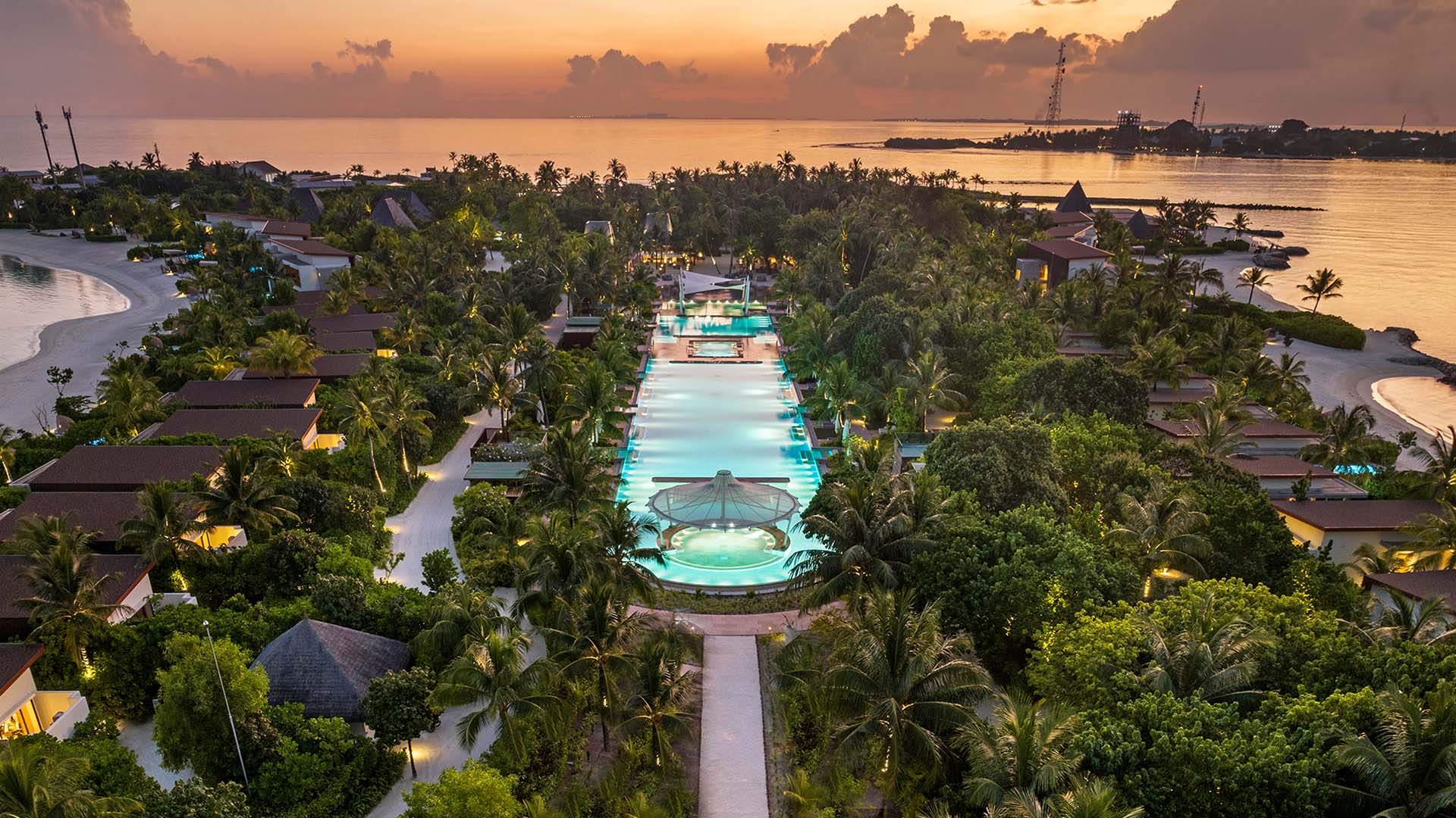 The largest pool at Kuda Villingili Maldives with stunning city view in the background