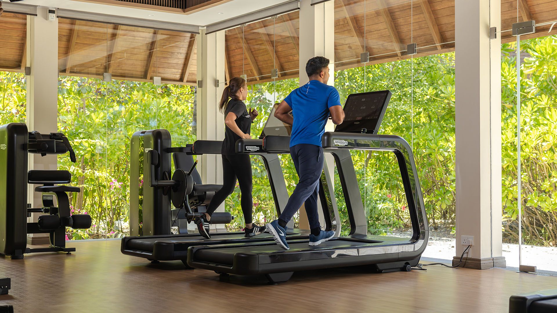 Couple exercising on treadmills at Kuda Villingili Maldives gym